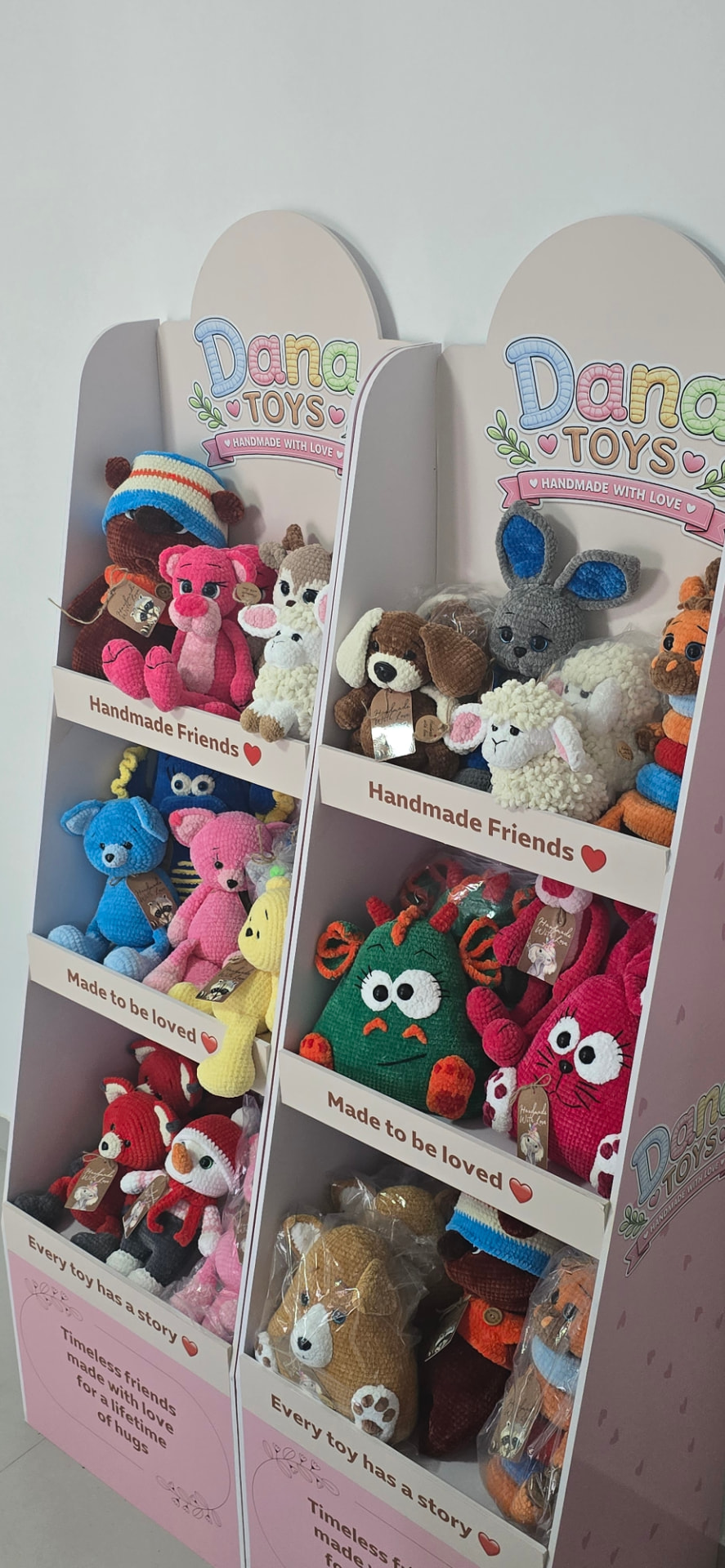 Two branded Dana Toys stands filled with handmade crochet toys
